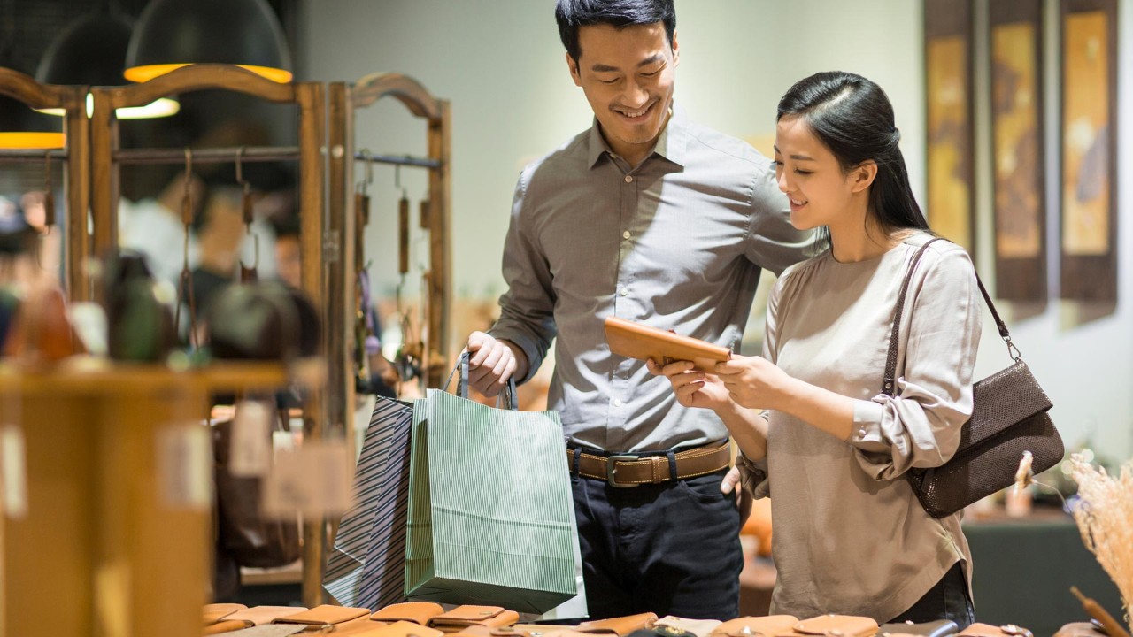 Young couple shopping in mall; image used for spend wisely