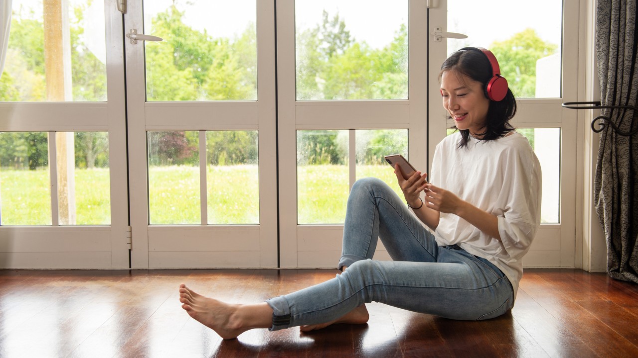 女孩坐在地板上看手机